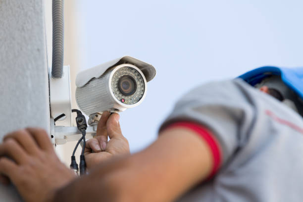 Technician installing a security camera